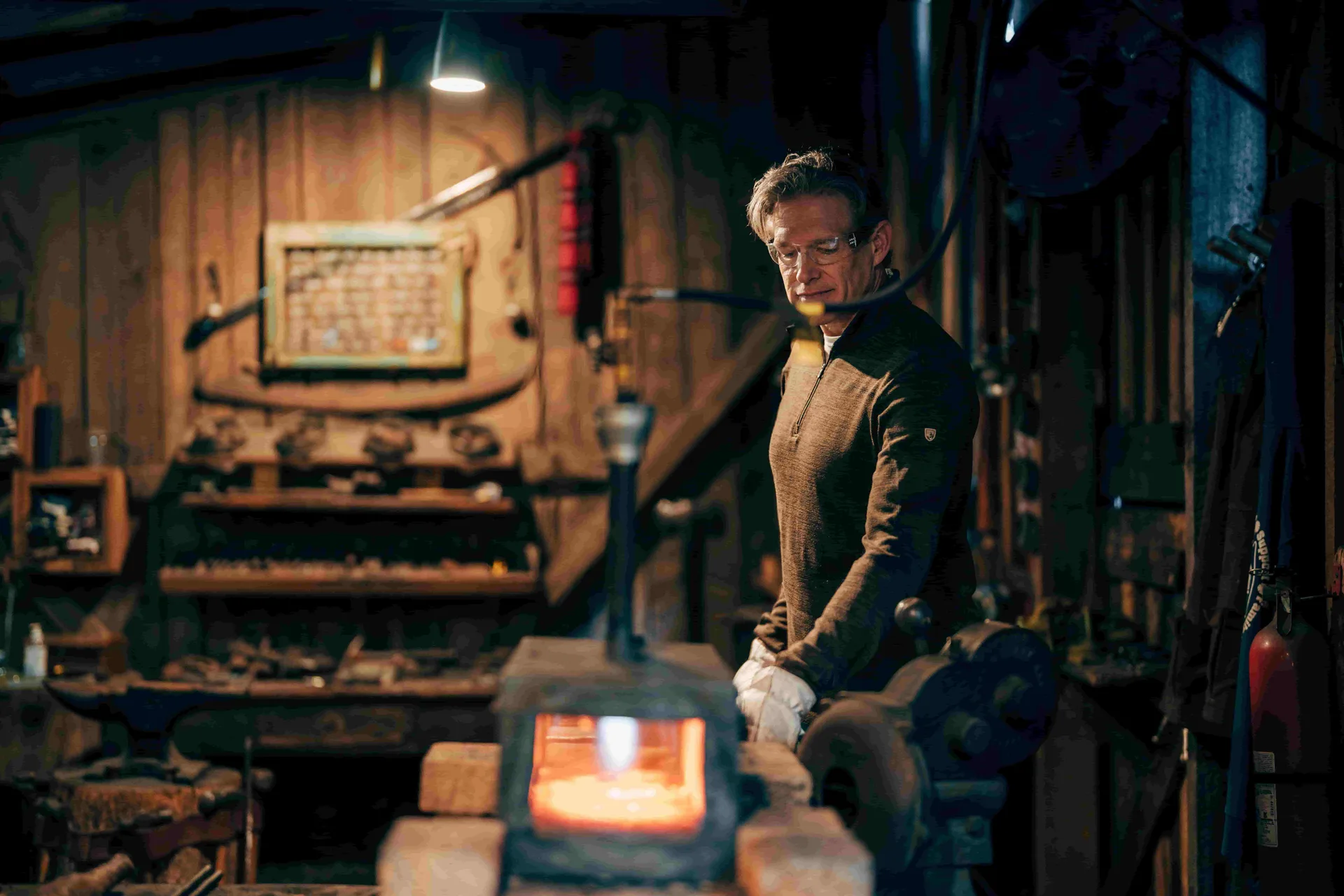 Smith at forge with glowing steel