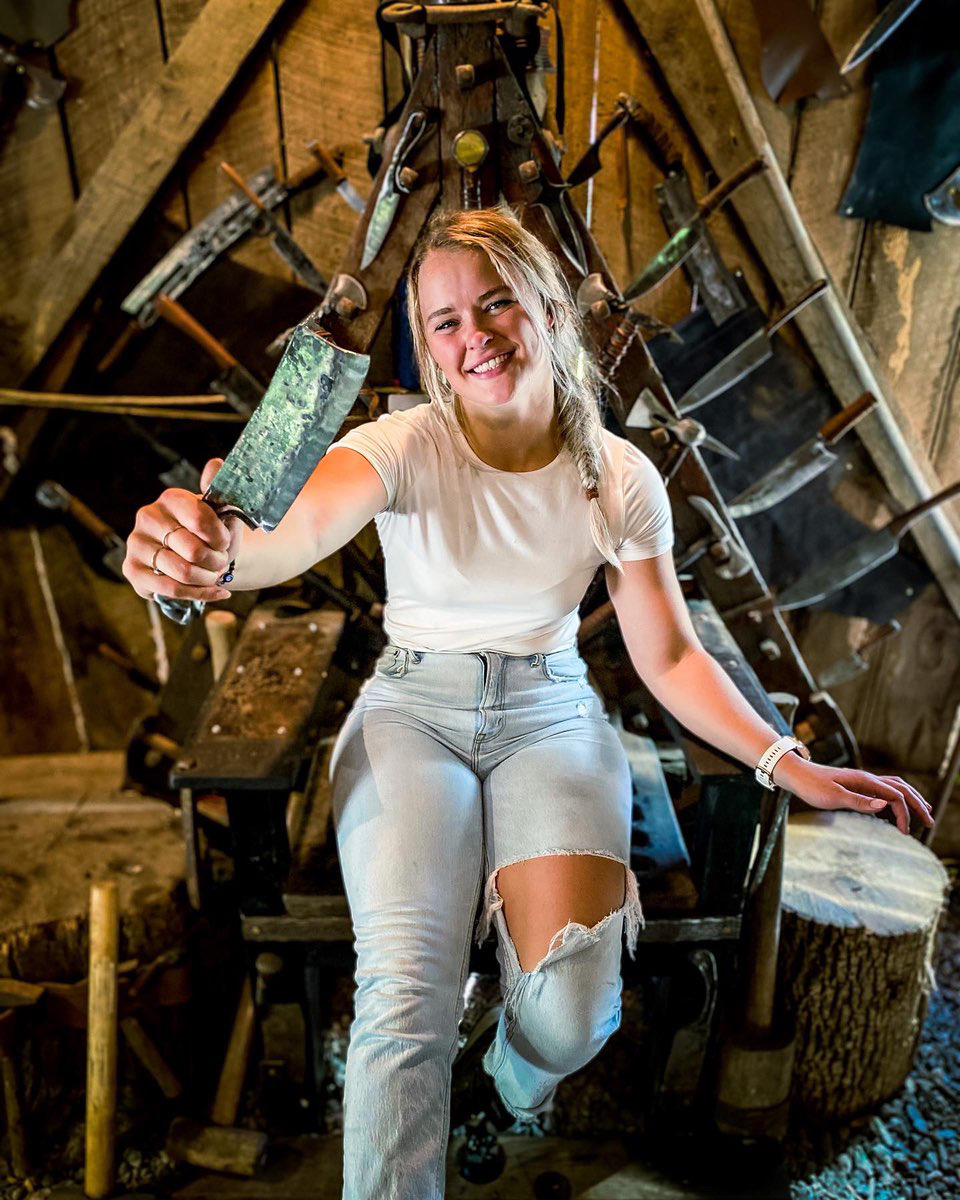 Guest proudly holding her finished forged blade