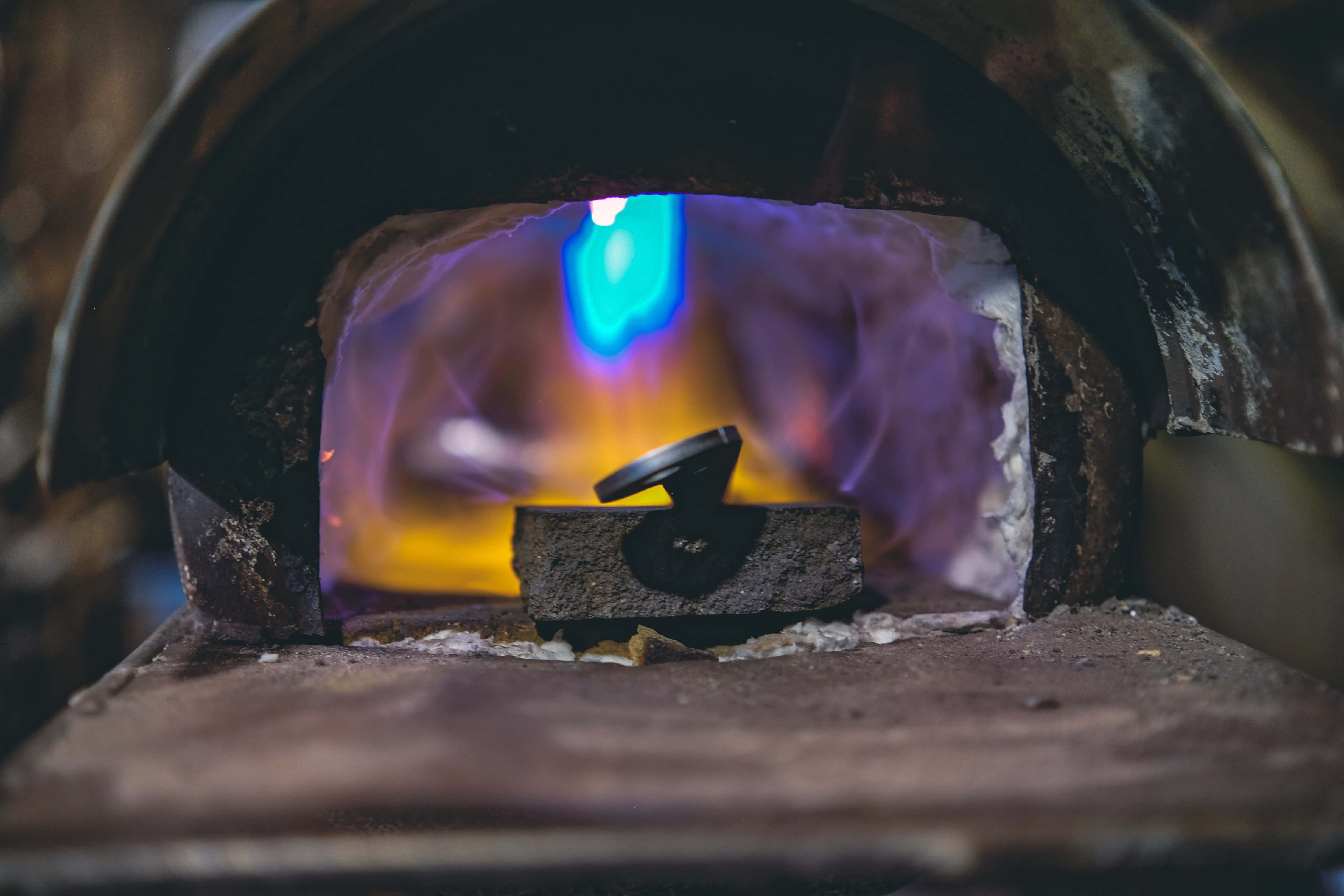 Hammer on anvil with forge glow