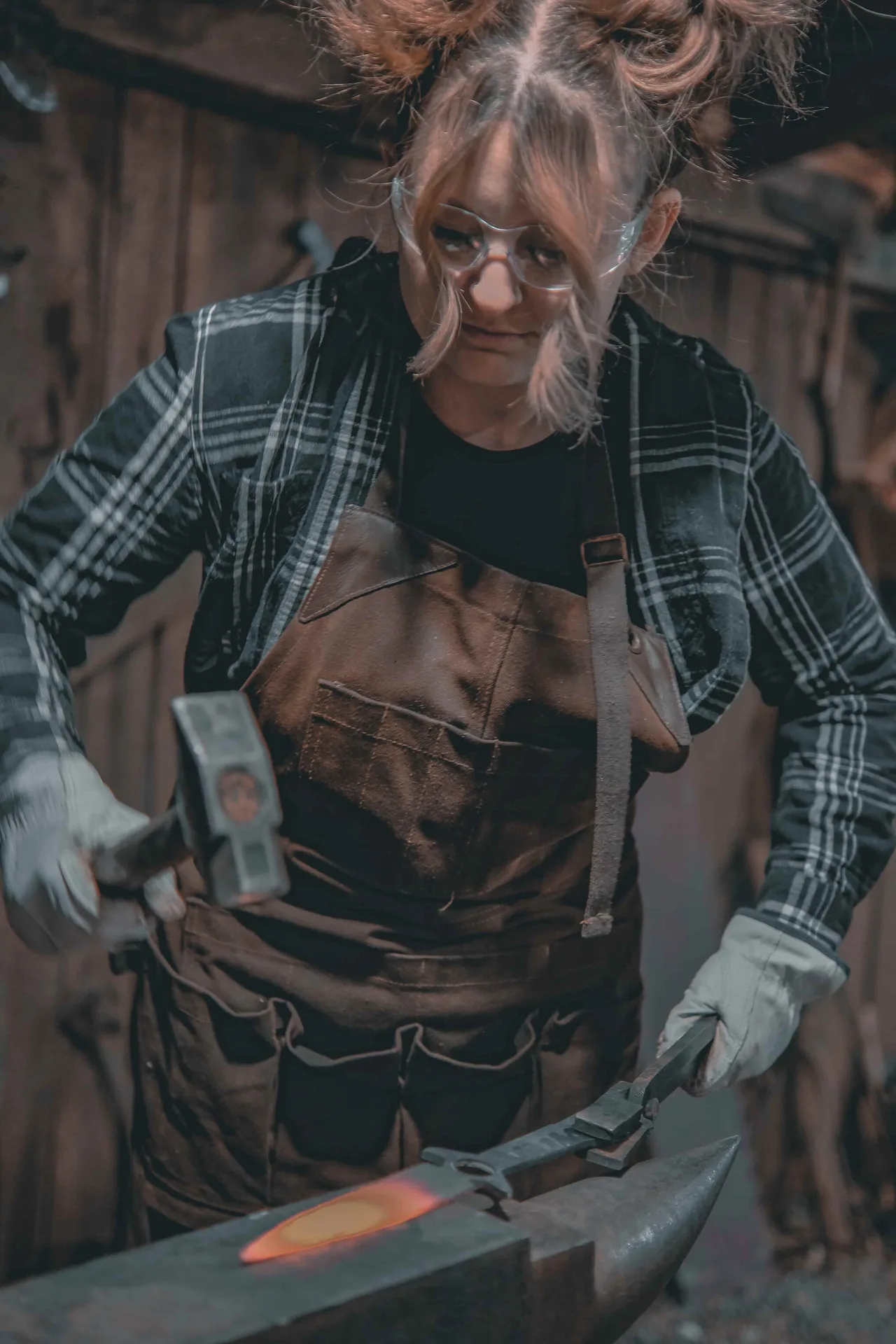 Woman forging her own blade at The Forge by Vikings Don't Cry near Asheville NC — perfect for bachelorette parties
