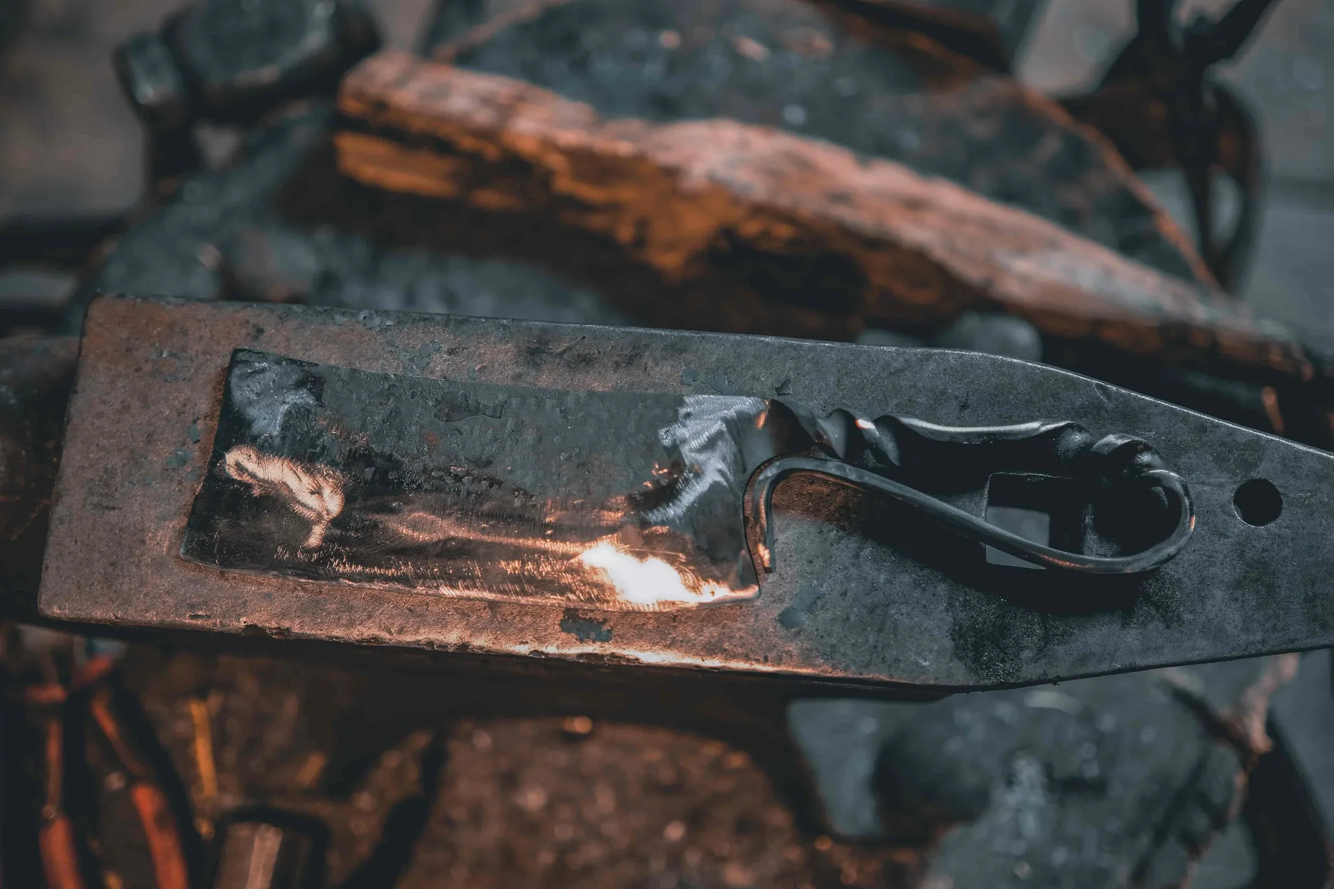 Woman hammering glowing blade